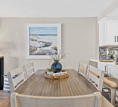Gather around this coastal-inspired dining table for memorable meals with loved ones in your serene beachside retreat.