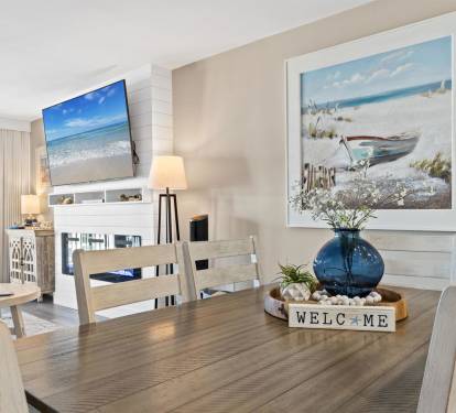 Gather around your spacious dining table where ocean views and coastal artwork create the perfect backdrop for memorable meals together.