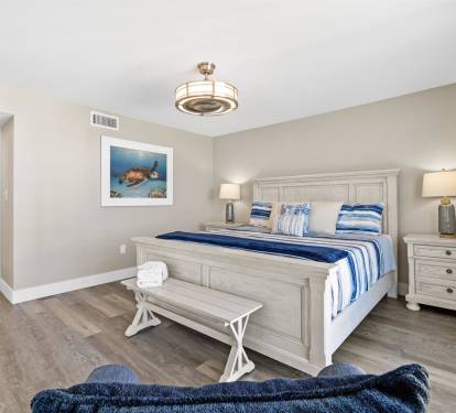 Your coastal bedroom features calming blue accents and white furnishings, creating a serene retreat for restful nights.