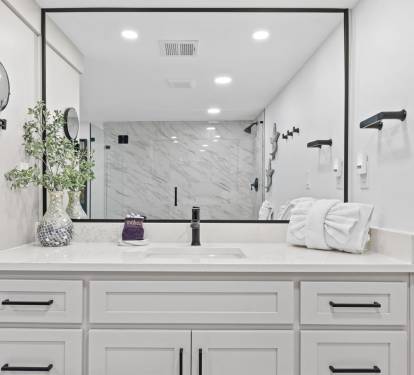 Step into your spa-like bathroom featuring elegant marble shower, pristine vanity, and luxurious amenities for ultimate relaxation.