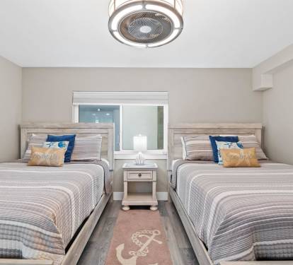 Your coastal retreat features twin beds with nautical touches, perfect for friends or family sharing peaceful moments together.