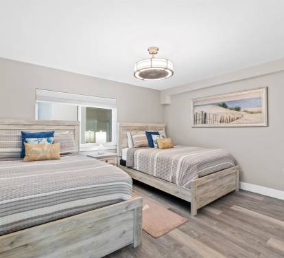 Drift off in this peaceful twin bedroom with coastal-inspired decor and premium linens for your perfect night's rest.