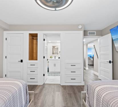 Your modern bedroom features twin beds, built-in storage, and an ensuite bathroom, creating the perfect retreat for restful nights.