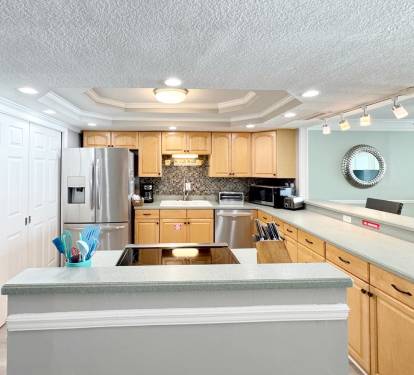 Your spacious kitchen features modern appliances, granite countertops, and an open island perfect for preparing meals and gathering together.