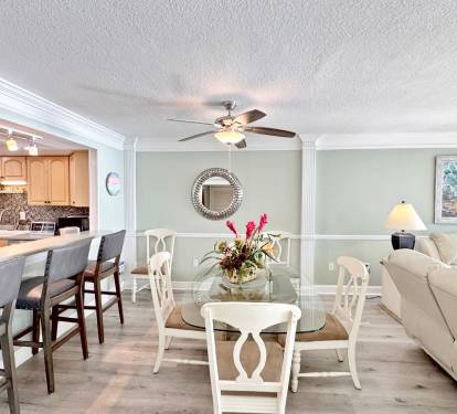 Step into this elegant open-concept space where coastal charm meets comfort—your perfect gathering spot for memorable meals and relaxation.