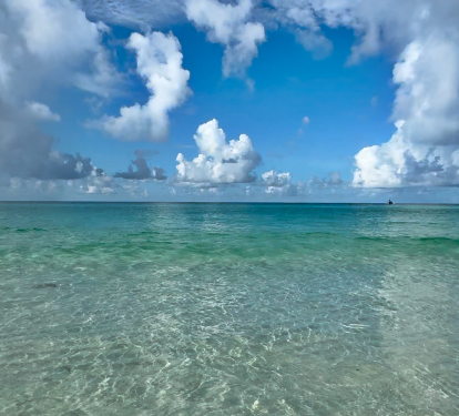 Pristine turquoise waters meet dramatic cloudy skies in this stunning coastal location near the property.