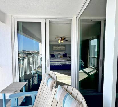 Your private balcony offers serene views and comfortable outdoor seating, seamlessly connecting to your cozy bedroom retreat.