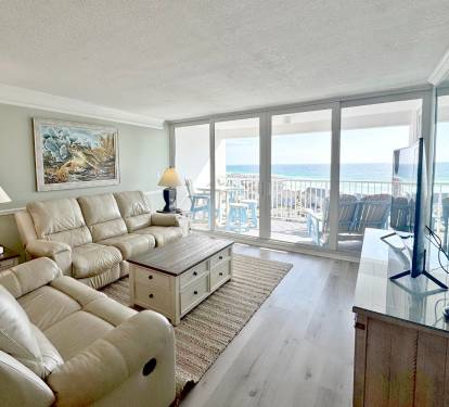Relax in your bright living room with plush recliners and stunning sea views through floor-to-ceiling windows.