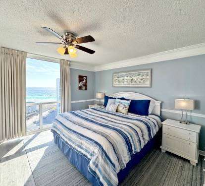 Wake up to breathtaking ocean views through floor-to-ceiling windows in your coastal bedroom sanctuary.