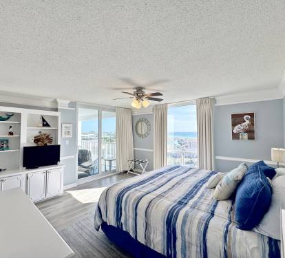 Wake up to stunning ocean views in your coastal bedroom, where soft blues mirror the sea beyond your balcony doors.