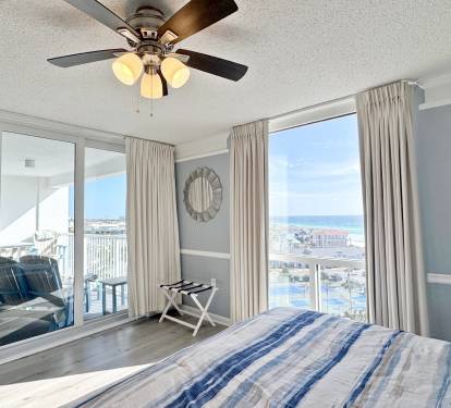 Wake up to stunning ocean views from your comfortable bedroom with private balcony access and gentle ceiling fan breezes.