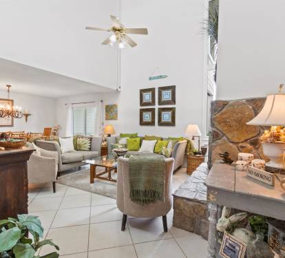 Sink into plush seating surrounded by warm coastal decor and thoughtful touches that make this inviting living space feel like home.