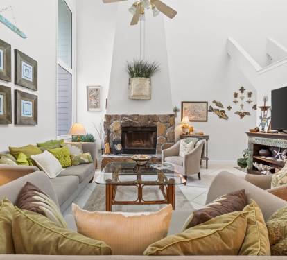 Sink into plush sofas around the stone fireplace, where warm lighting and thoughtful touches create your perfect gathering space.