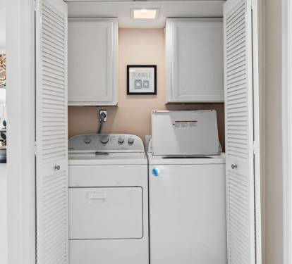 Your private laundry nook keeps you fresh throughout your stay, tucked away behind elegant white louvered doors.