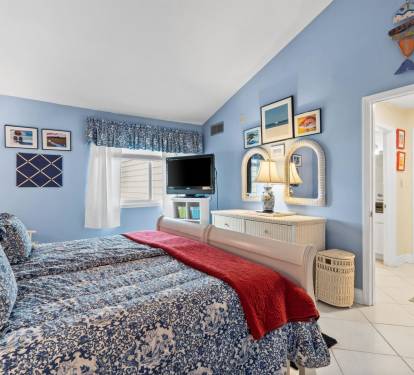 Your peaceful coastal bedroom features ocean-themed décor, comfortable bedding, and your own TV for relaxing evenings by the sea.