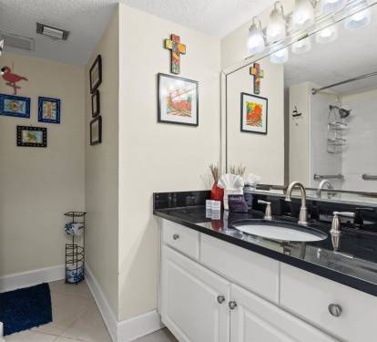 Refresh in your private bathroom with sleek granite counters, bright vanity lighting, and a step-in shower.