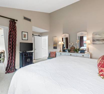 Sink into your plush king bed surrounded by elegant furnishings, warm lighting, and thoughtful touches that make this spacious retreat feel like home.
