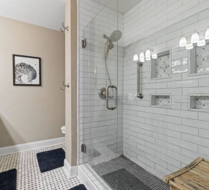 Step into your spa-like bathroom oasis with gleaming subway tiles, rainfall shower, and marble accents creating the perfect retreat.