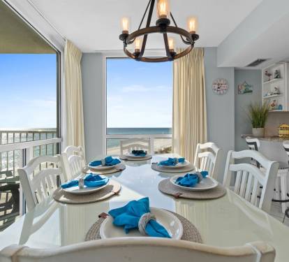 Savor meals at your elegant dining table with stunning ocean views flowing through floor-to-ceiling windows.