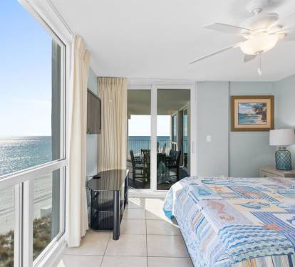 Wake to stunning ocean views through floor-to-ceiling windows in your coastal bedroom, where morning light dances across the waves just beyond your private balcony.