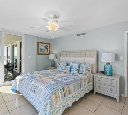 Wake up to ocean views from your peaceful bedroom, featuring a comfortable bed and coastal decor that creates the perfect seaside retreat.