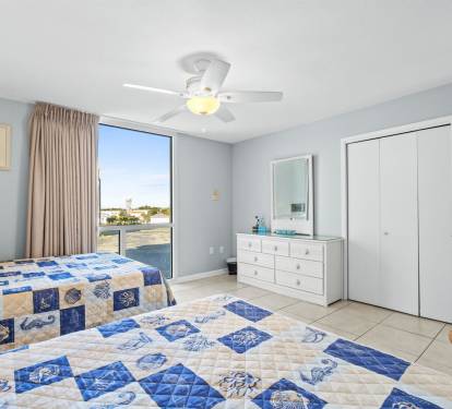 Drift off to sleep in your coastal-themed bedroom with twin beds, ceiling fan comfort, and stunning water views beyond your window.