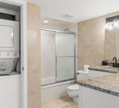 Step into your spacious bathroom featuring elegant granite countertops, a refreshing shower, and convenient in-unit washer and dryer for your comfort.
