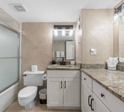 Refresh in your spacious bathroom with granite counters, glass shower, and modern fixtures.