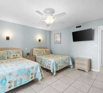 Rest peacefully in your coastal-themed twin bedroom with calming sea blues, comfortable bedding, and your own TV for relaxing evenings.