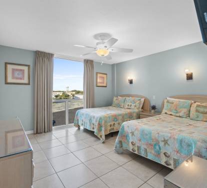 Drift off in these cozy twin beds with ocean-themed bedding, while gentle sea breezes flow through your private oceanfront room.