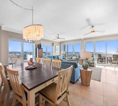 Your open-concept living space features panoramic windows flooding the room with natural light and stunning city views.