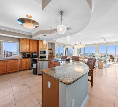 Your gourmet kitchen opens to stunning city views through floor-to-ceiling windows, creating the perfect space for cooking and entertaining.