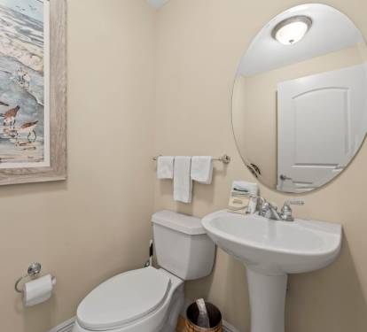 Your private powder room features coastal-themed art and fresh linens, creating a welcoming space for freshening up during your stay.