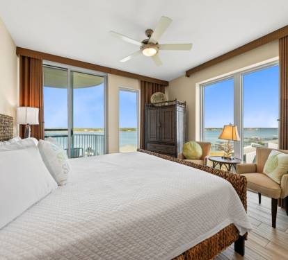 Wake up to stunning water views from your king bed, where morning light filters through floor-to-ceiling windows and gentle breezes flow.