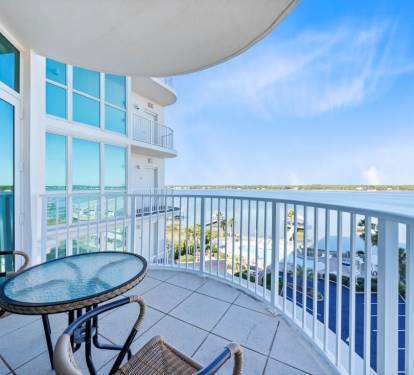 Sip your morning coffee while watching boats drift across pristine waters from your private curved balcony.