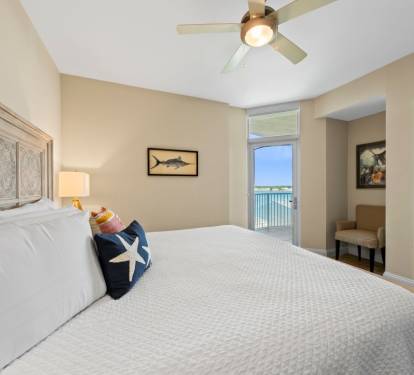 Wake up to stunning water views from your comfortable bed with coastal decor and gentle ceiling fan breezes.