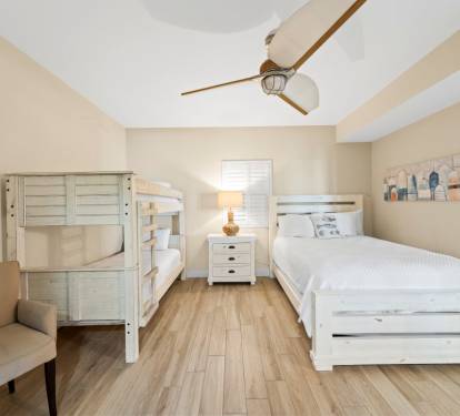 Your family can rest comfortably in this bright bedroom with fresh white bedding and coastal charm.