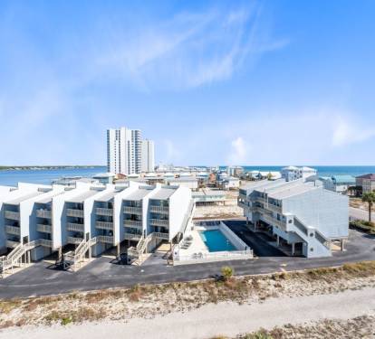 Coastal resort complex with beach access, swimming pool, and modern accommodations near the Gulf waters.