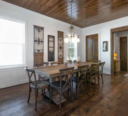 Gather around this stunning farmhouse dining table where warm wood meets elegant charm for memorable meals together.