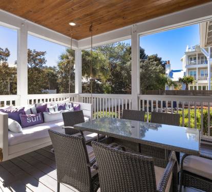 Your private screened balcony awaits with a cozy daybed swing and dining for six—perfect for morning coffee or evening meals.