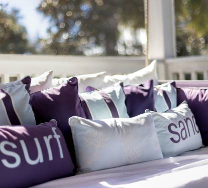 Sink into plush cushions on your private balcony, where 'surf' and 'sand' pillows invite lazy afternoons in the sun.