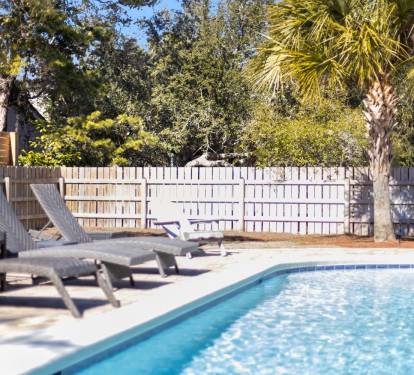 Dive into your private oasis where sparkling blue waters await beneath swaying palms and sunny skies.