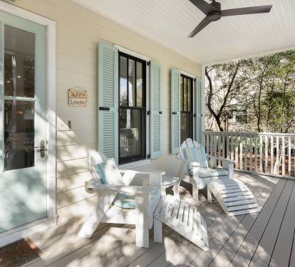 Settle into your peaceful covered porch with Adirondack chairs and watch the day unfold through leafy trees.