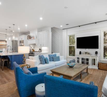 Relax in your open-concept living space where coastal blues meet crisp whites, creating the perfect backdrop for memorable vacation moments.