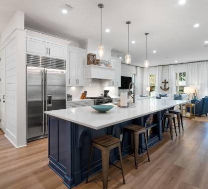 Your stunning open-concept kitchen flows seamlessly into the living area, featuring stainless steel appliances and a spacious island perfect for meal prep.