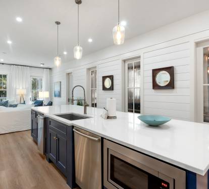 Your modern coastal kitchen invites culinary adventures with gleaming countertops, premium appliances, and charming nautical touches throughout.