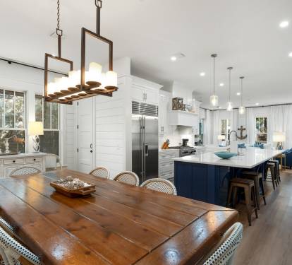 Your open-concept kitchen and dining space creates perfect memories around the rustic farmhouse table while you cook together.