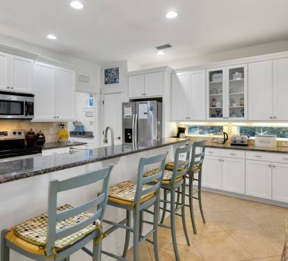 Your bright, fully-equipped kitchen welcomes you to cook meals together, featuring granite counters and breakfast bar seating.