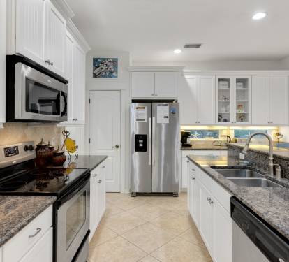 Cook your favorite meals in this elegant kitchen featuring granite counters, stainless appliances, and everything you need for a perfect stay.