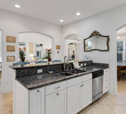 Cook your favorite meals in this elegant kitchen featuring granite countertops, stainless steel appliances, and an open island perfect for gathering.